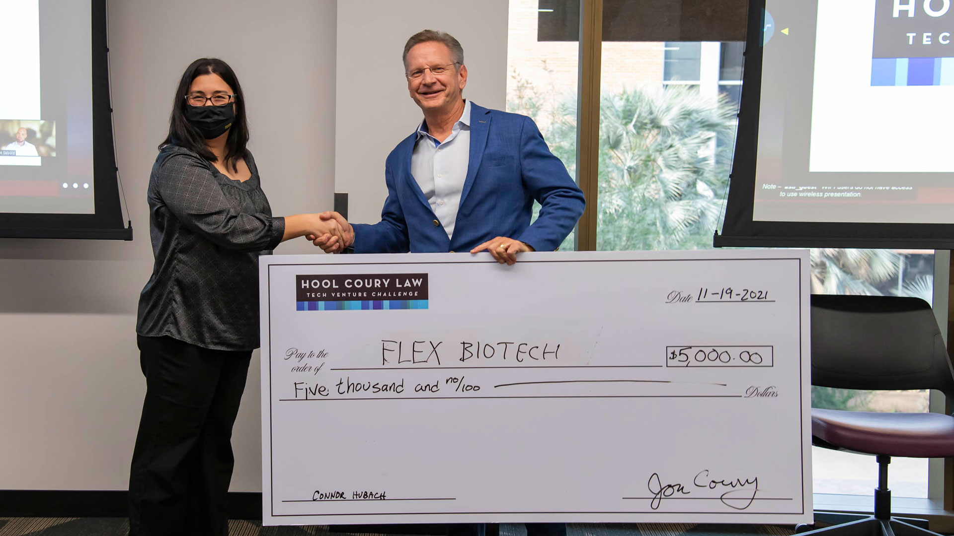 Michael Hool presents a $5,000 check to Jennifer Blain Christen at the ASU Hool Coury Law Tech Venture Showcase.