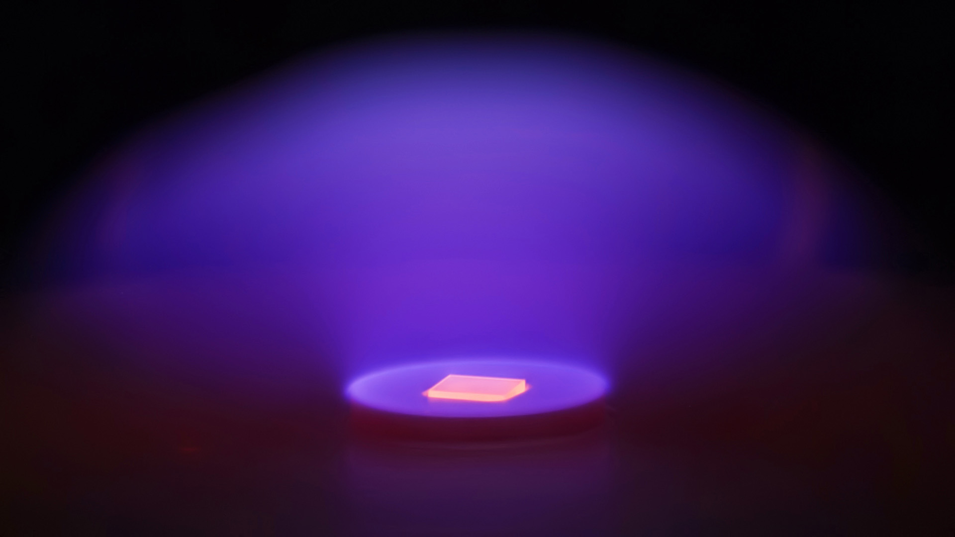 An artificial diamond being grown in lab equipment