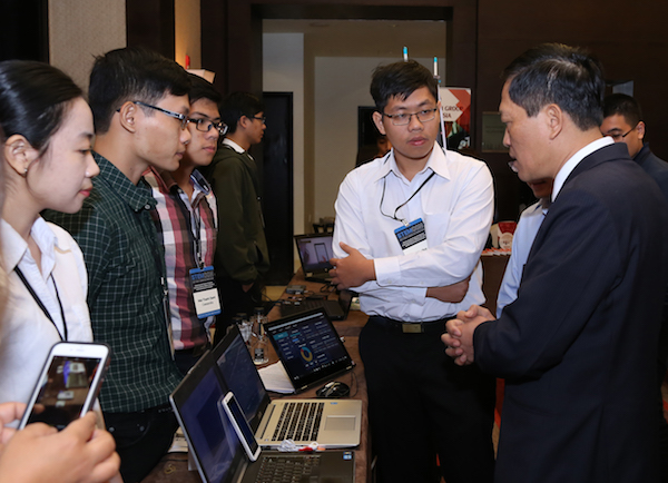 Photo of students demonstrating on a laptop with a caption of "Winners of the 2017 National Instruments Innovation Design Competition for Young Entrepreneurs showcase their winning internet of things home cardiac surveillance system, “CASSANDRA.”"