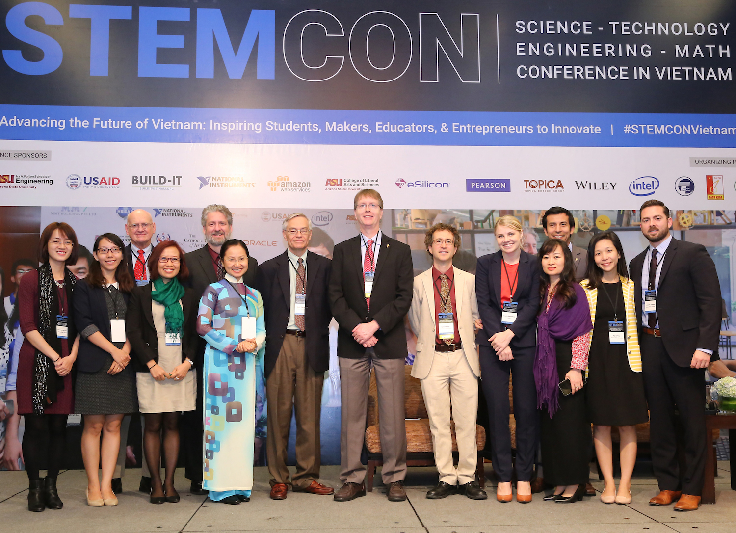 Photo of group standing with a caption of "ASU staff with USAID Vietnam Social Development Unit Chief Ezra Simon (Sixth from right) at STEMCON. From Left:  Huong Nguyen, Thanh Ta, Marcus Ingle, Thao Tran, David Benson, Phuong Nguyen, Scott Danielson, Kyle Squires, Ezra Simon(USAID), Sasha Stinchfield, Phuong Anh Tran, Octavio Heredia, Cristal Ngo, Jose Quiroga. (Photo courtesy of HEEAP.)"