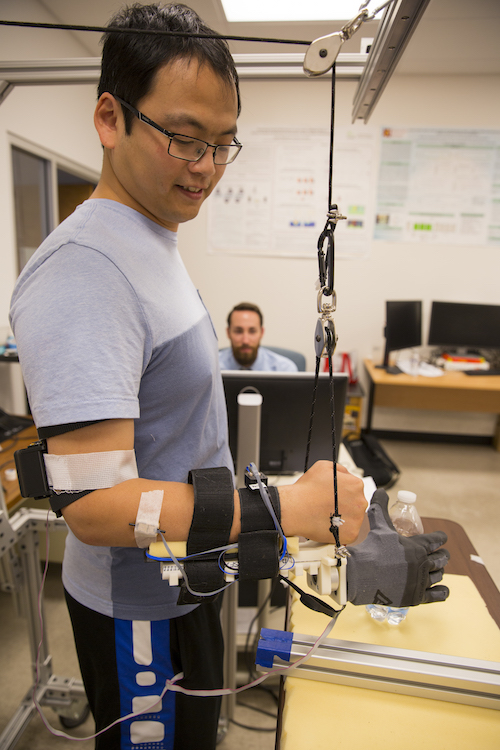 Assistant Research Professor Qiushi Fu is shown demonstrating a synergy-based prosthetic hand