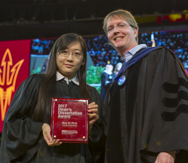Photo of Bing Si holding a plaque next to Kyle Squires. Caption: Bing Si received the 2017 Dean's Dissertation Award from Dean Kyle Squires at the Fulton Schools' Fall 2017 Convocation. Photographer: Jessica Hochreiter/ASU