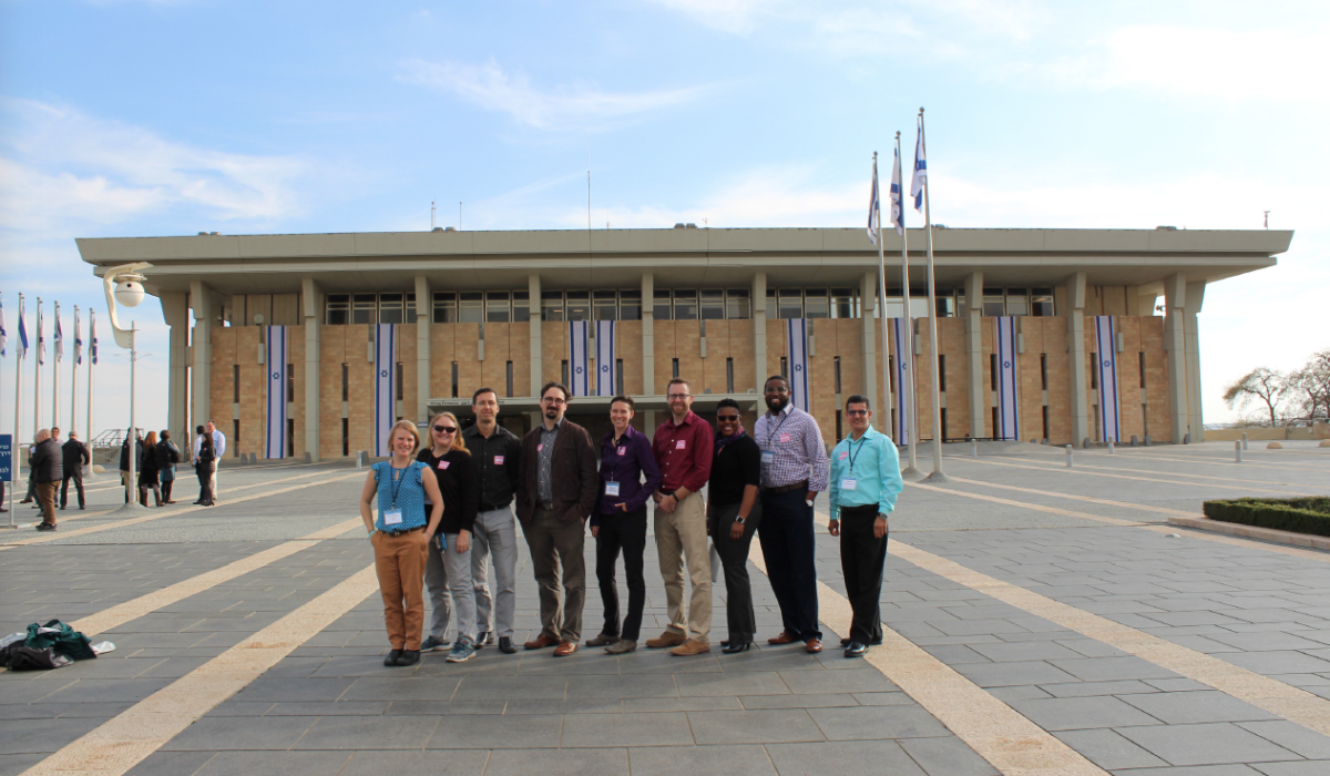 Photo of a group of people standing in front of a building. Caption: The ASU group poses outside the entrance to the Israeli Parliament building, called the Knesset, in Jerusalem. Photograph courtesy of Jeremi London/ASU