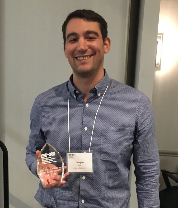 Portrait of Douglas Rice holding trophy. Caption: Doctoral student Douglas Rice won awards for both a nanotechnology research poster competition and a Nano Pitch to judges on a research project proposal. Photographer: Ana Barrios/ASU