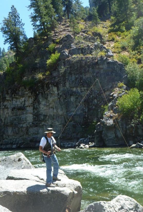 Photo of a man fishing. Caption: Nerison also spends his retirement traveling with his wife and fishing in Idaho's beautiful rivers in the summer. Photo courtesy of John P. Nerison, PE