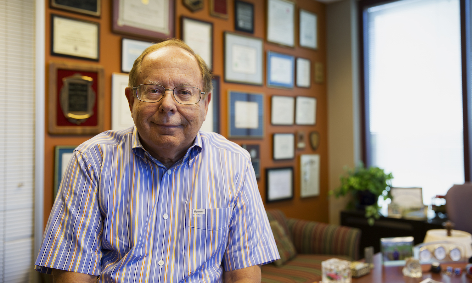 Photo of Doug Montgomery in his office. Caption: Regents’ Professor Douglas Montgomery has established a charitable reminder trust to help fund graduate education and a new professorship in industrial engineering in the Fulton Schools. Photographer: Jessica Hochreiter/ASU