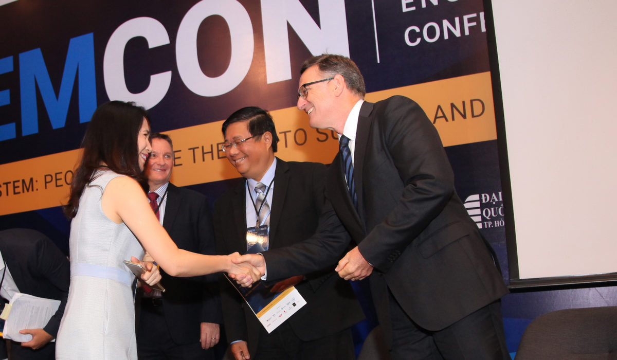 Tran Thi Yen Dinh (far left), education sector director with Microsoft Vietnam, shakes hands with Oracle Academy Asia Regional Director Damian Haas as they prepare to discuss public private partnerships in the era of Industry 4.0.