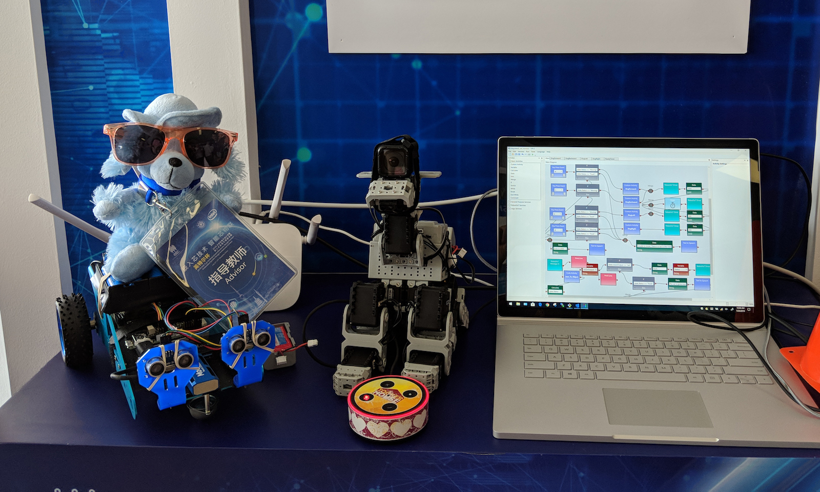 laptop next to a robotic dog and wheelchair