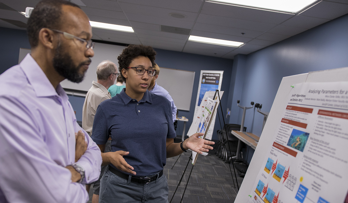 two people looking at poster