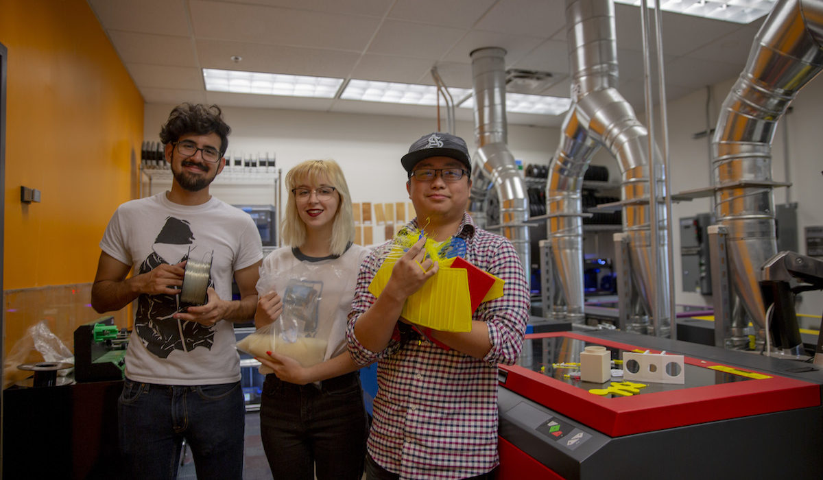 Mechanical engineering sophomore Kenny Truong holds waste PLA pieces from the lab. Computer science freshman Morgan Kennedy holds a bag of pellets made of new plastic from manufacturer Filabot that the lab team used to test the extruder tool. Mechanical engineering senior Ruy Garciaacosta holds a spool of recycled filament.