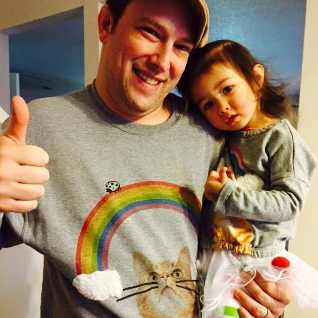 photo of man holding a child