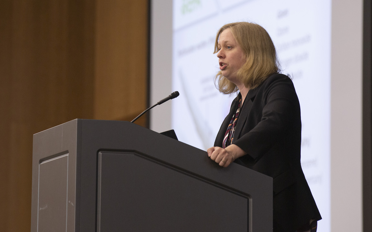 woman speaking at a lectern