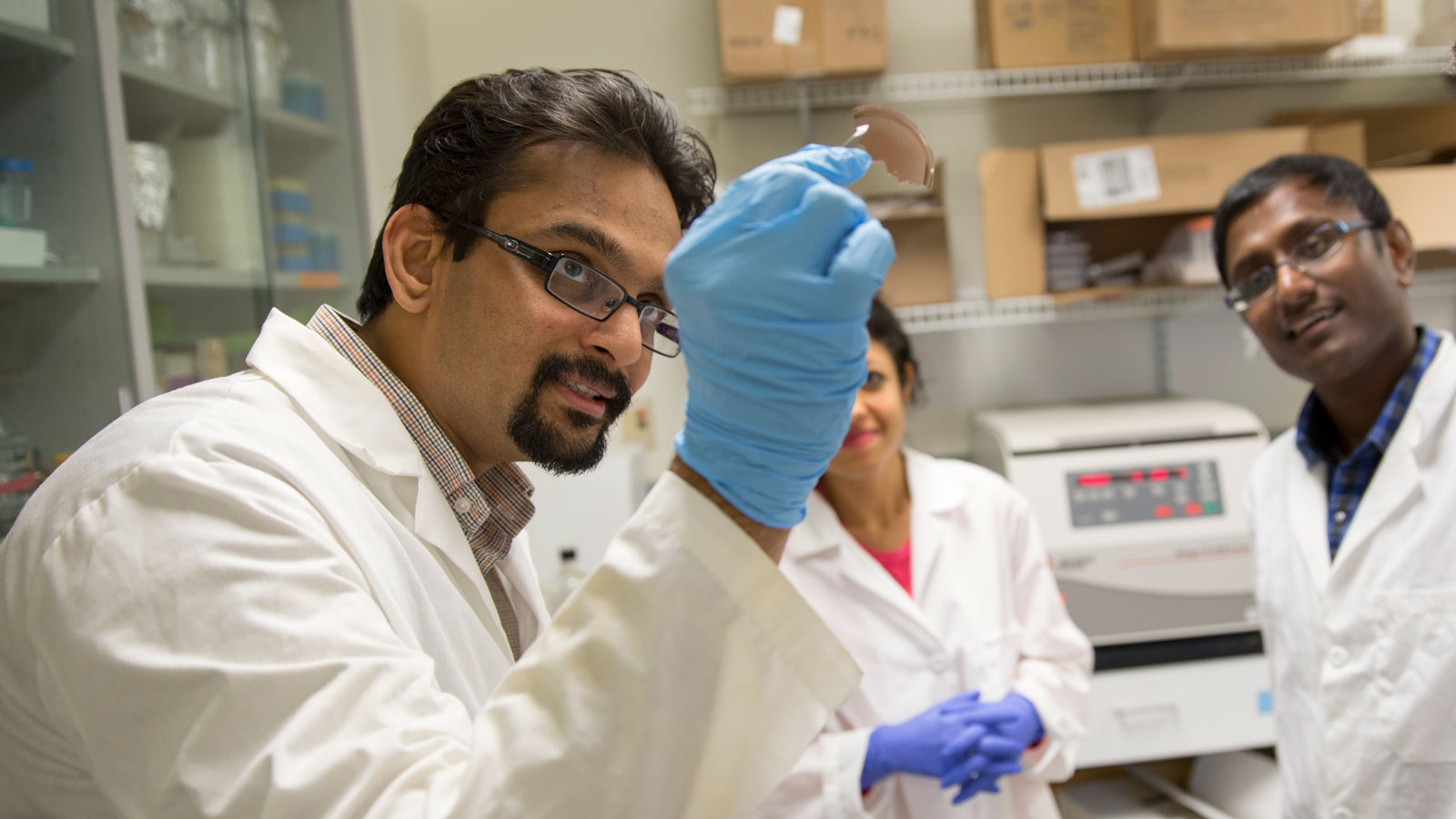 Professor and students in a lab