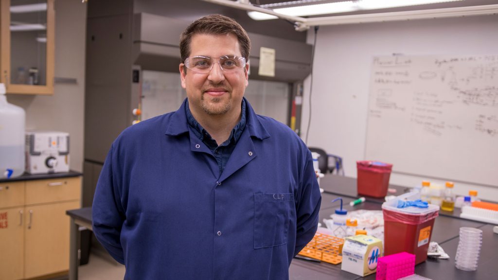 Christopher Plaisier poses in his lab at Arizona State University.