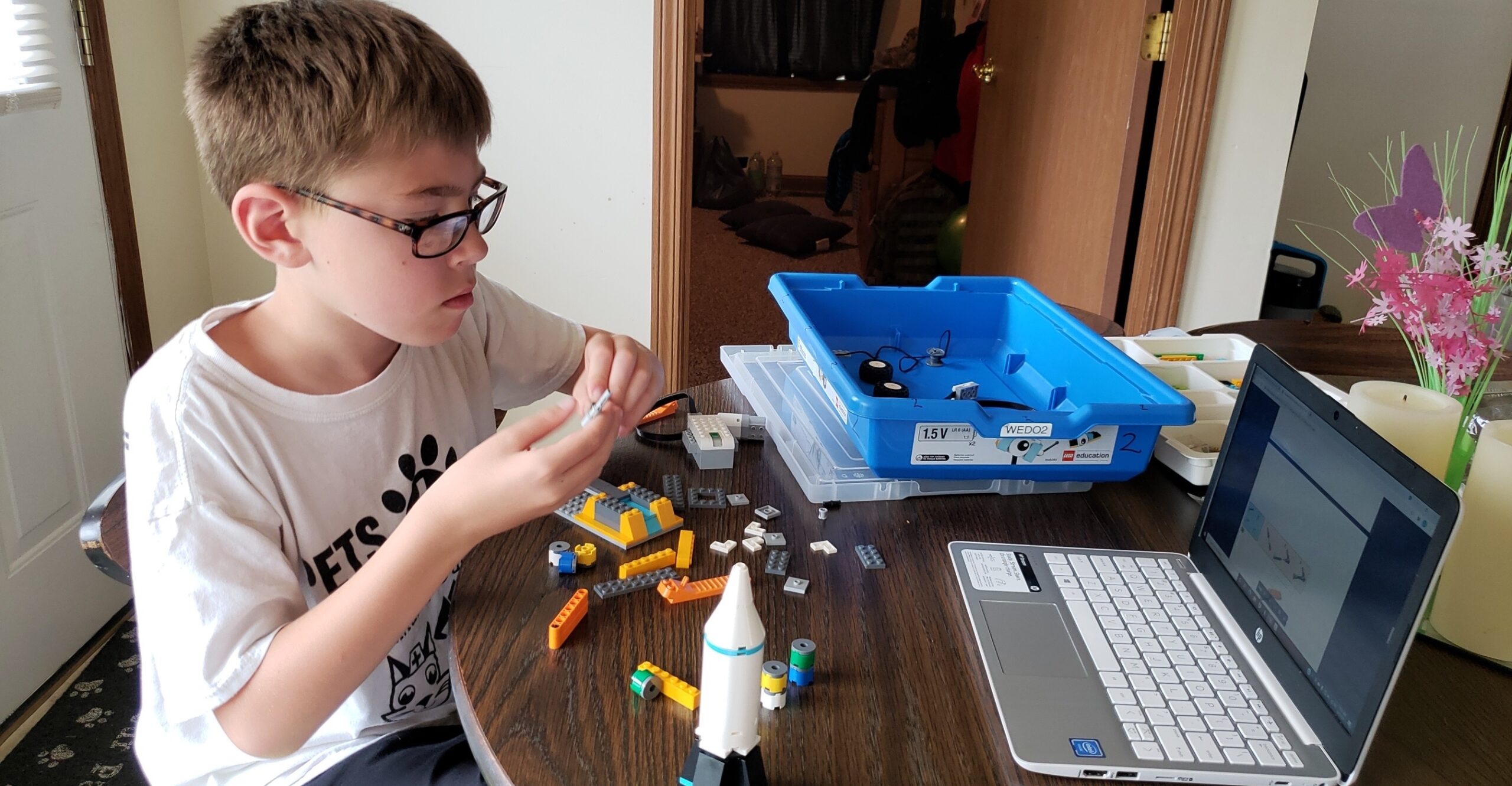 student buliding a LEGO robot project during a virtual summer camp