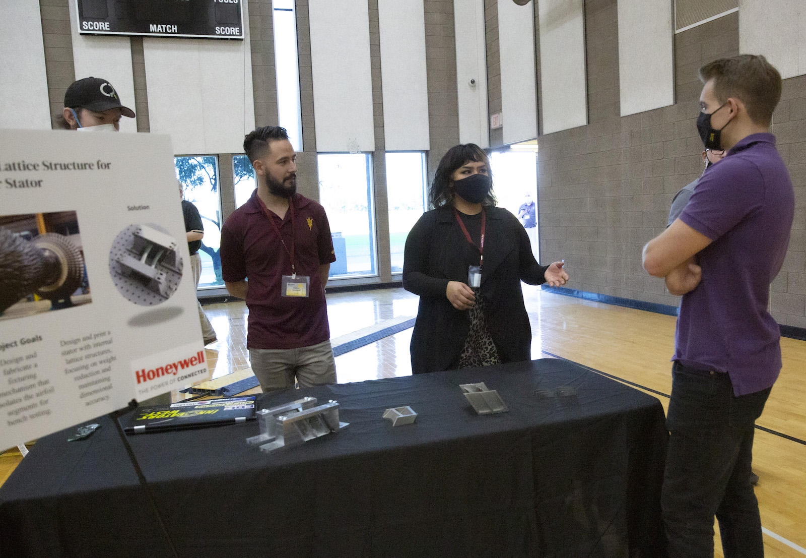 Three people speaking to each other during Innovation Showcase
