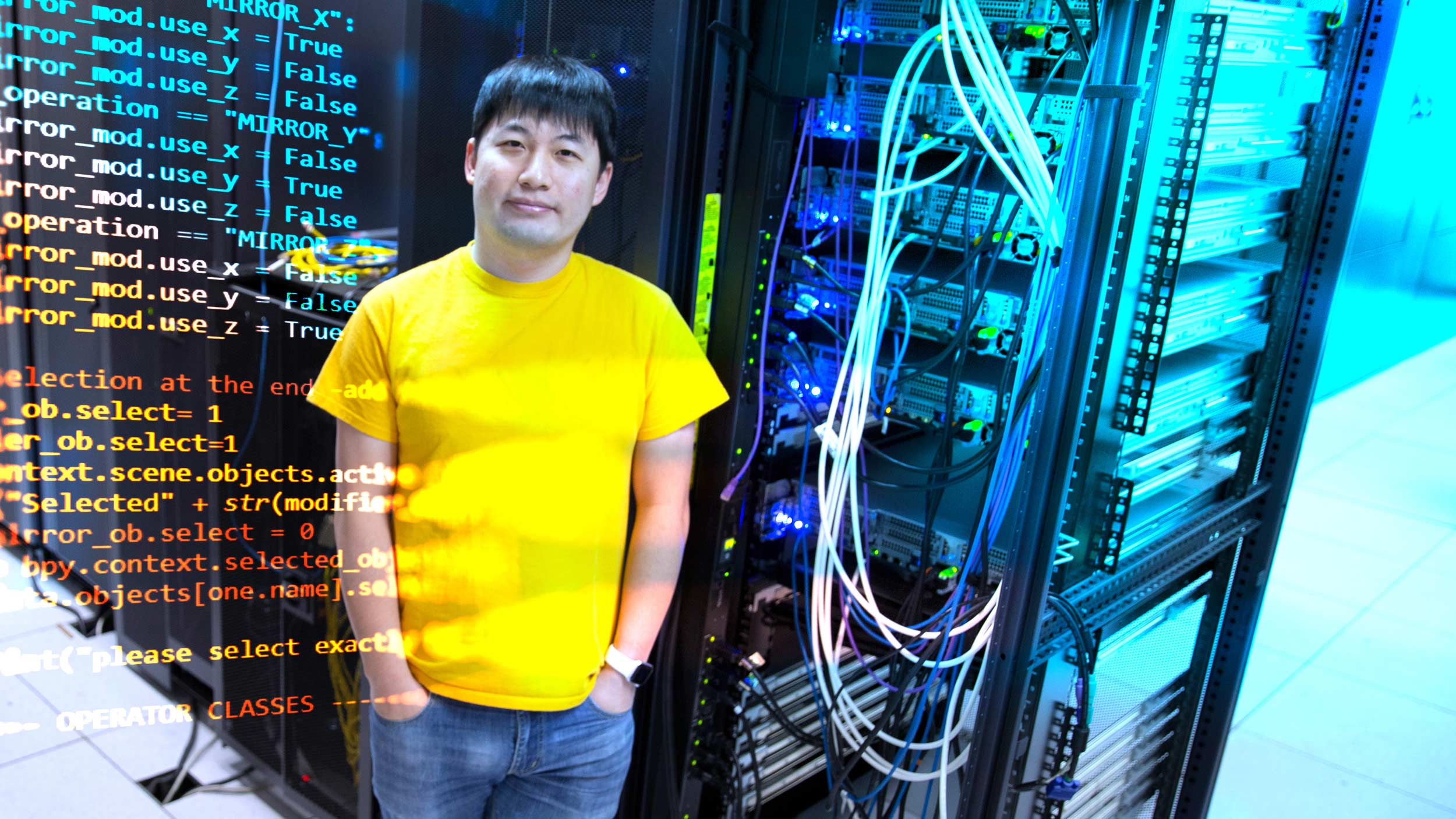 CAREERAward-FishWang-v1w Fish Wang standing next to computer processors