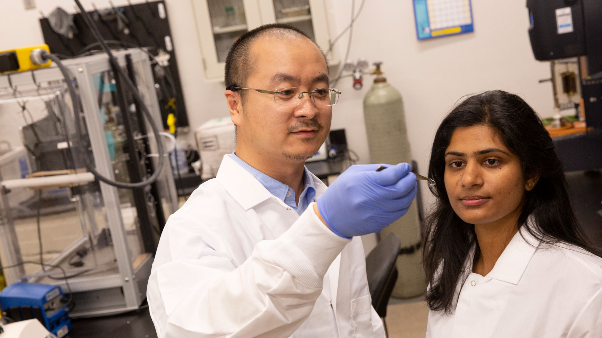 Kenan Song and Mounika Kakarla in a lab