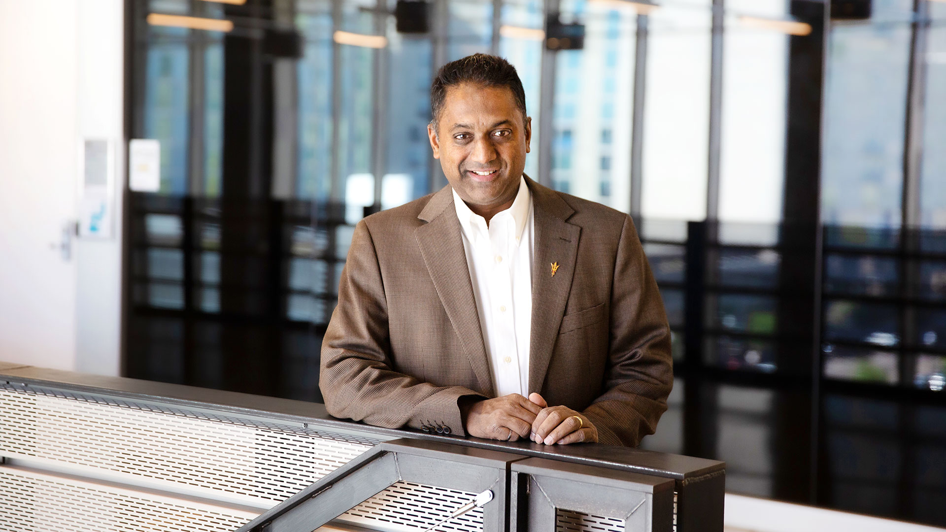 Sam Ariaratnam standing at a railing