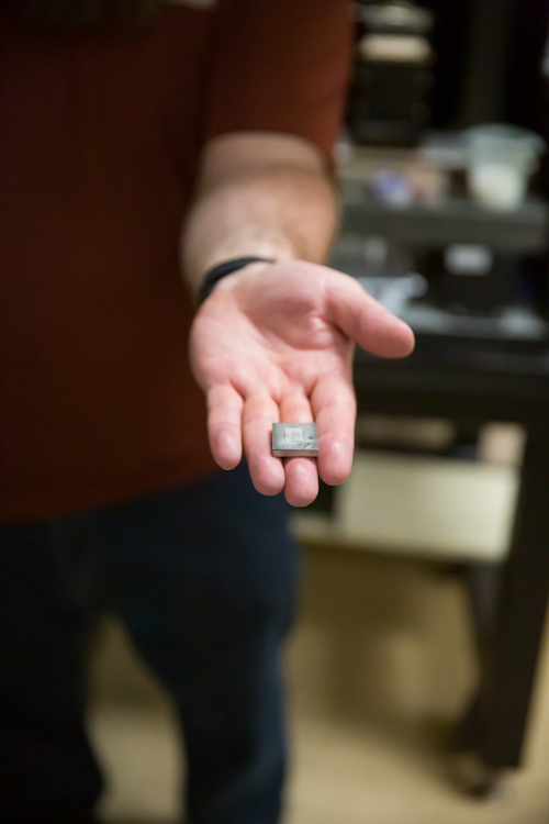 Christian Hoover holding a glass sample