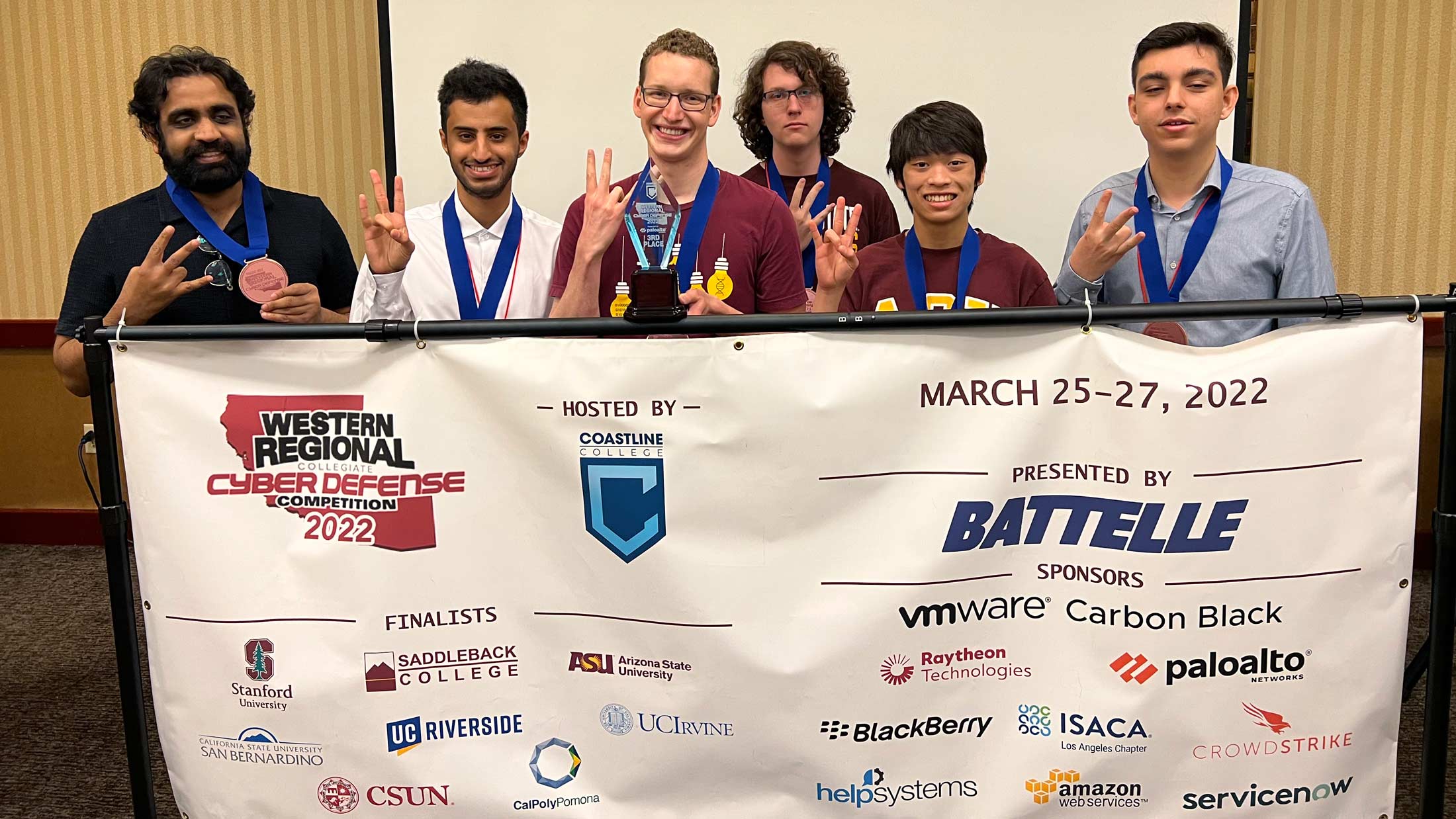 Members of ASU's CDDC team posing with third place trophy behind a banner advertising the CDDC Western Regioanl competition