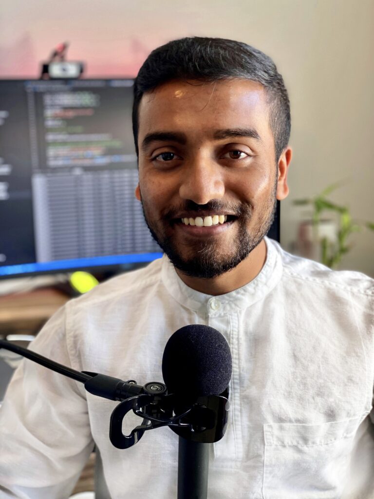 ASU Graduate Research Associate Jay Shaw pictured at a microphone.