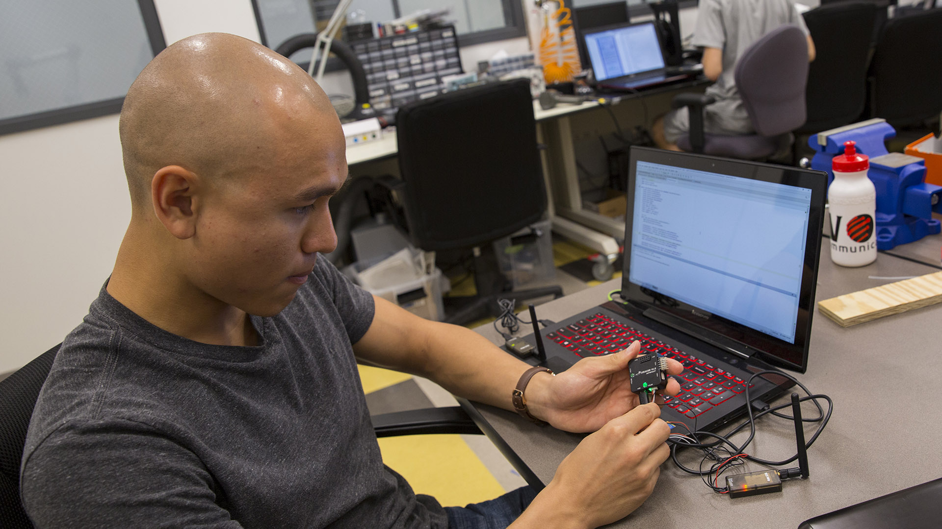 student working with electrical components and a laptop