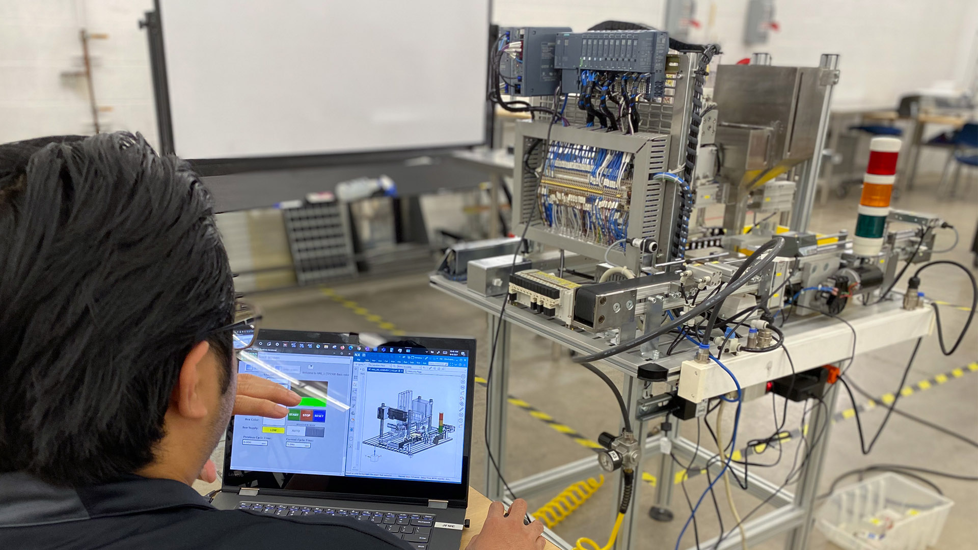 Jean-Francois Enriquez working on a laptop computer with other equipment