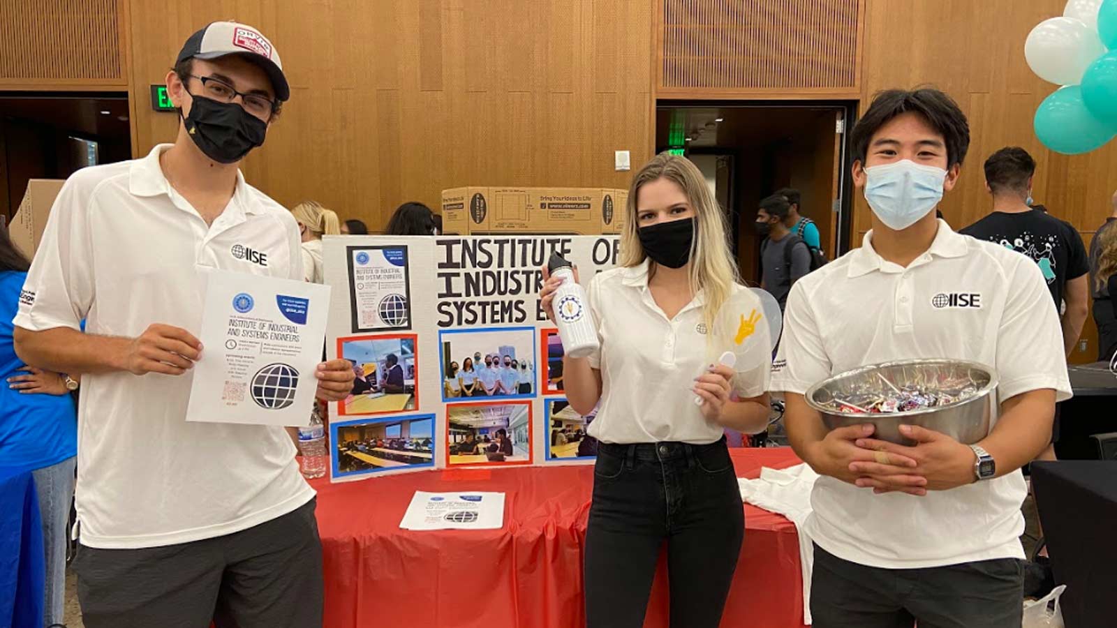 Three students in front of a table