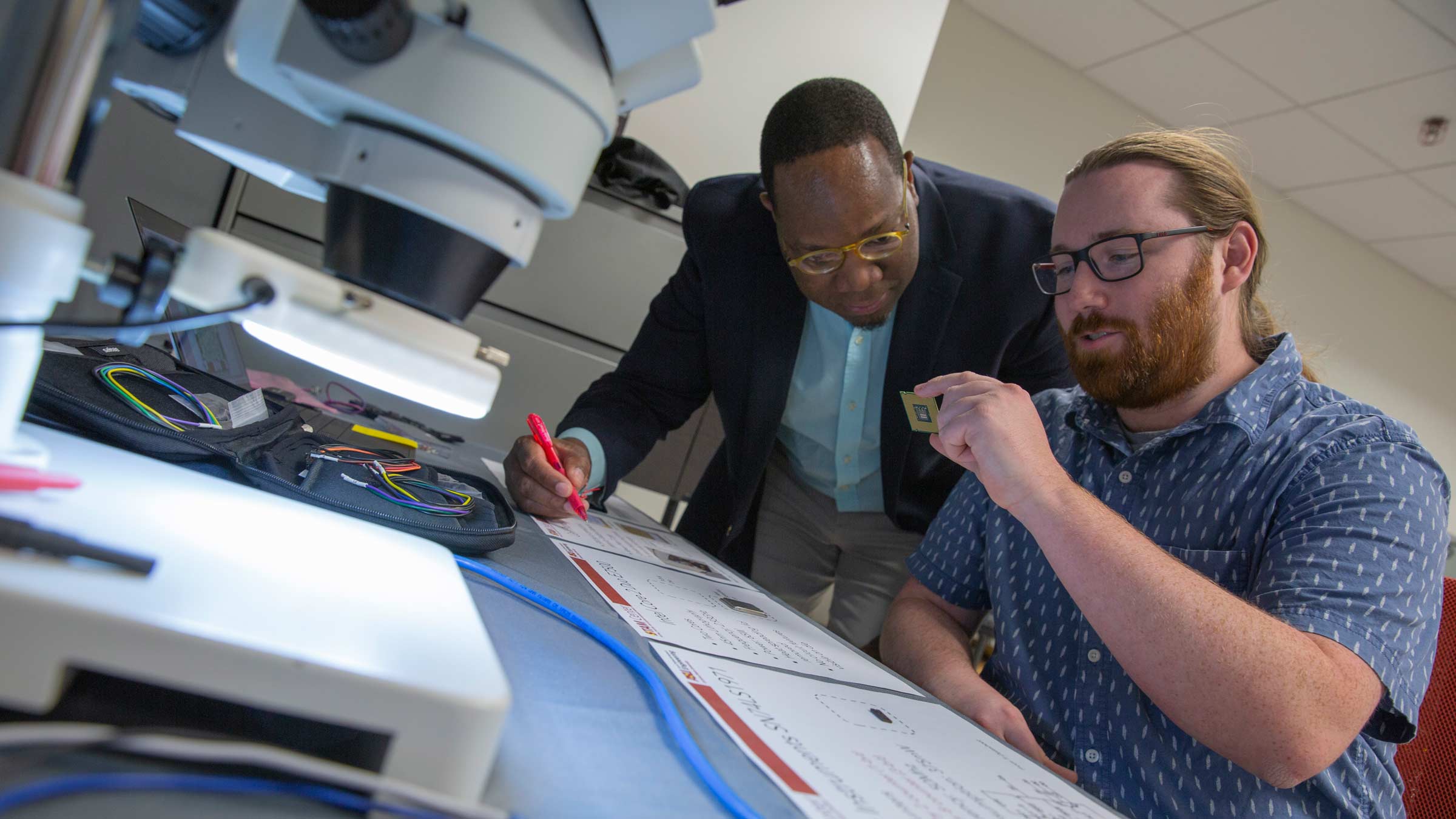 Alan Ehret and Michel Kinsy working together