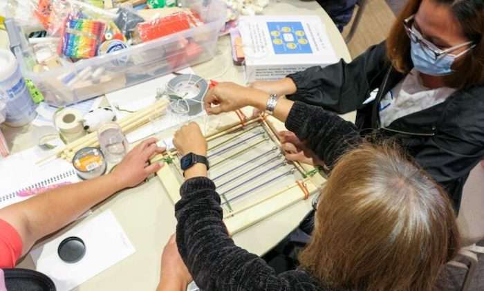 Members of the Helios Rocketry student org stand at their Fulton Schools Homecoming Block Party Exhibit