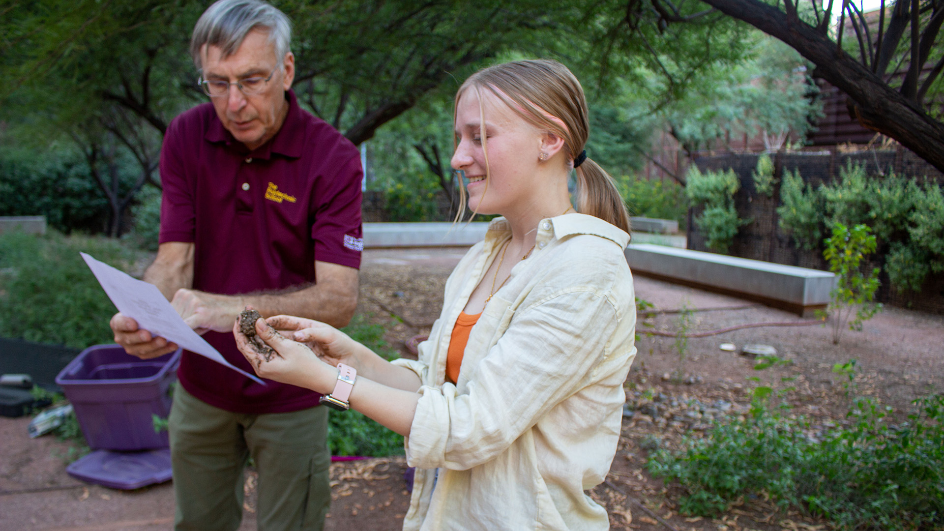 Erin Shriner adding water to soil