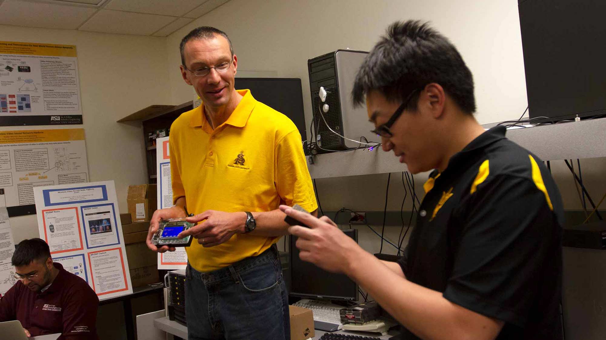 Martin Reisslein observes a student's project in Reisslein's lab.