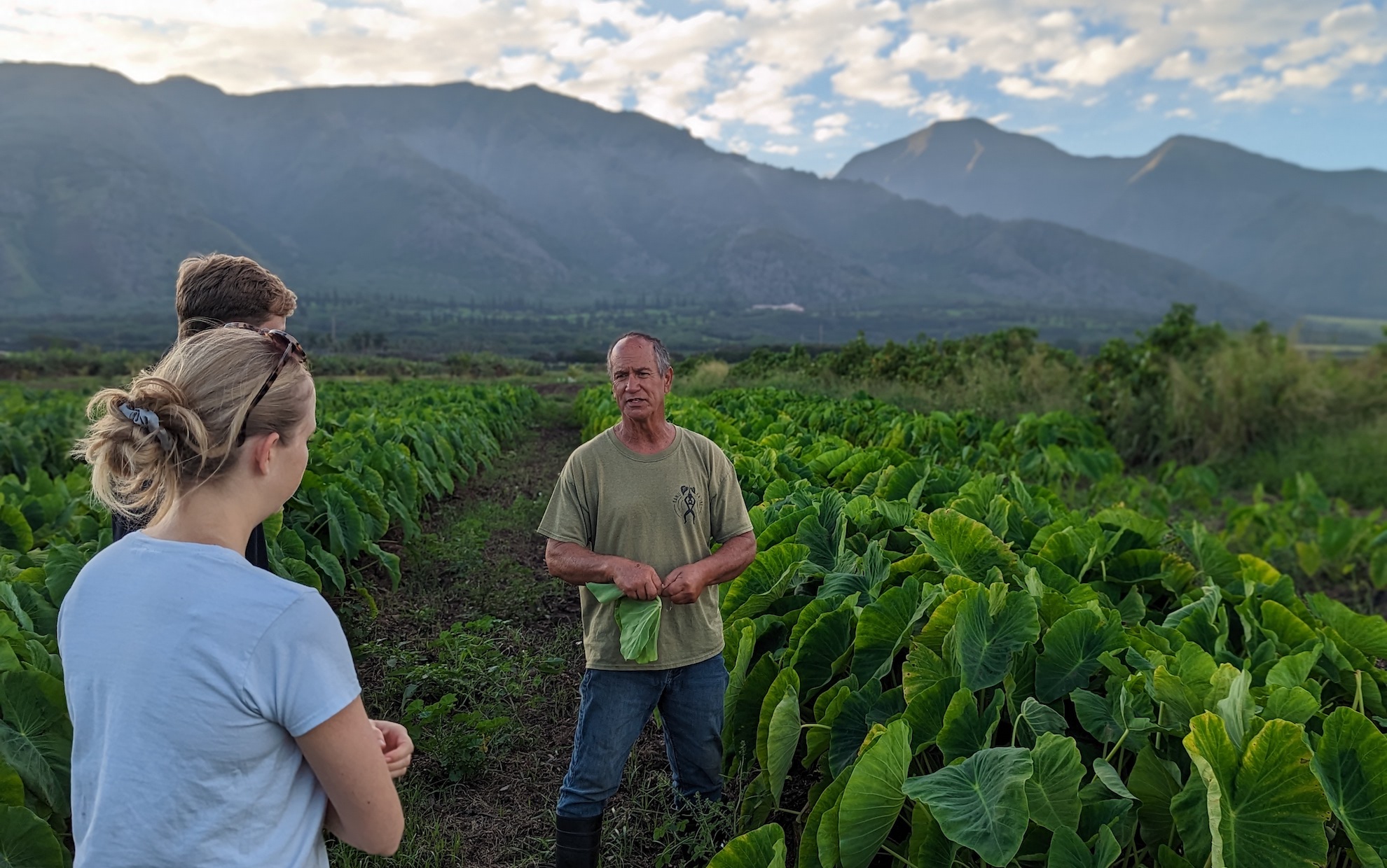 Hannah Kerner in field discussing crops