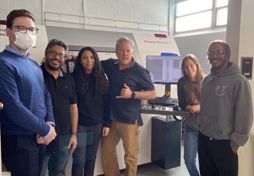 six people standing in a lab