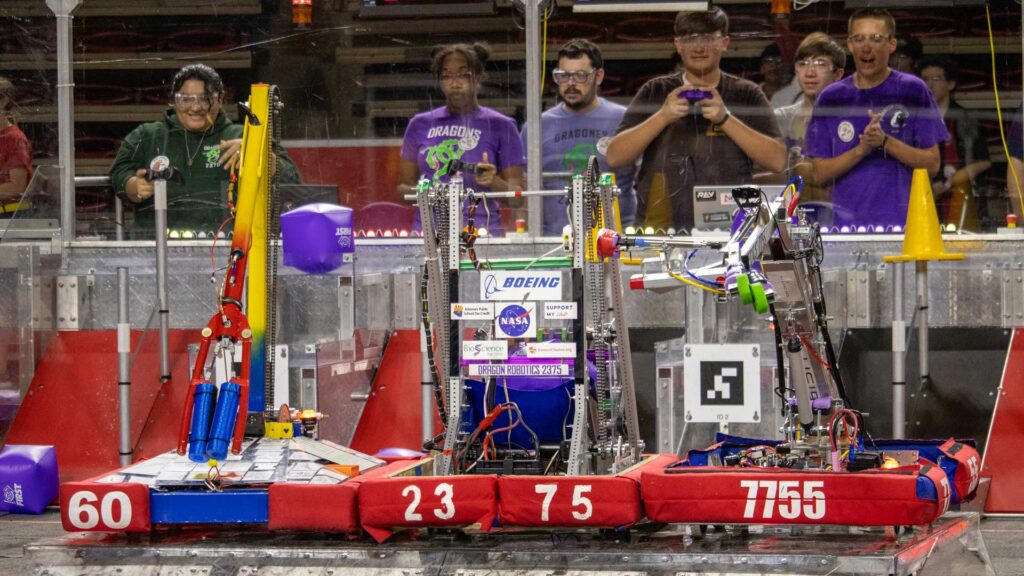 Students control their robots during a challenge in the 2023 Arizona FIRST Robotics Competition State Championship.