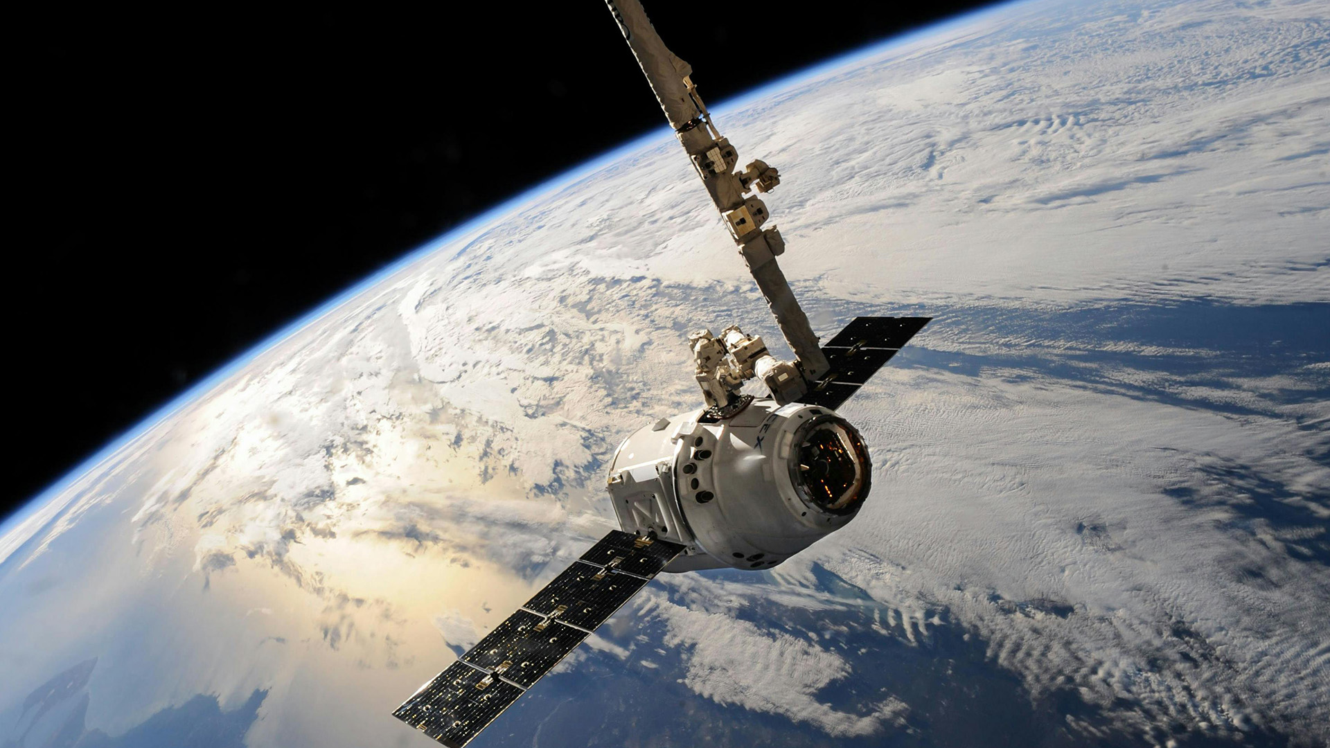 pexels-spacex-586056-1920×1080 A satellite is shown in space above Earth.