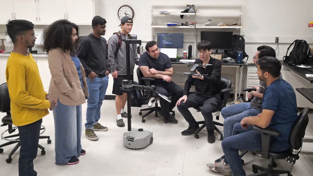 Zhe Xu and some of his students in a classroom 