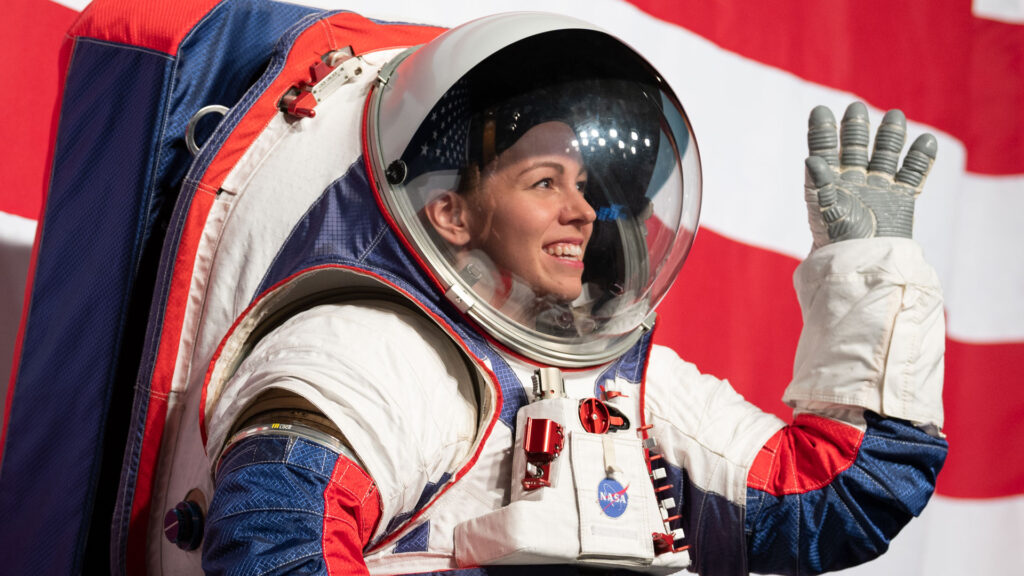 A NASA spacesuit engineer wears a prototype spacesuit.