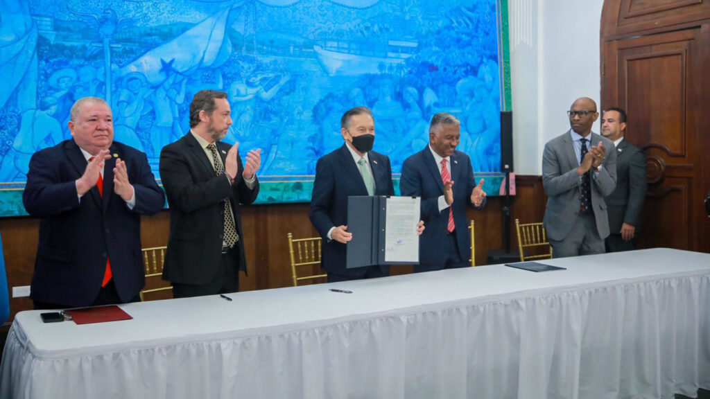 group standing at a table after signing