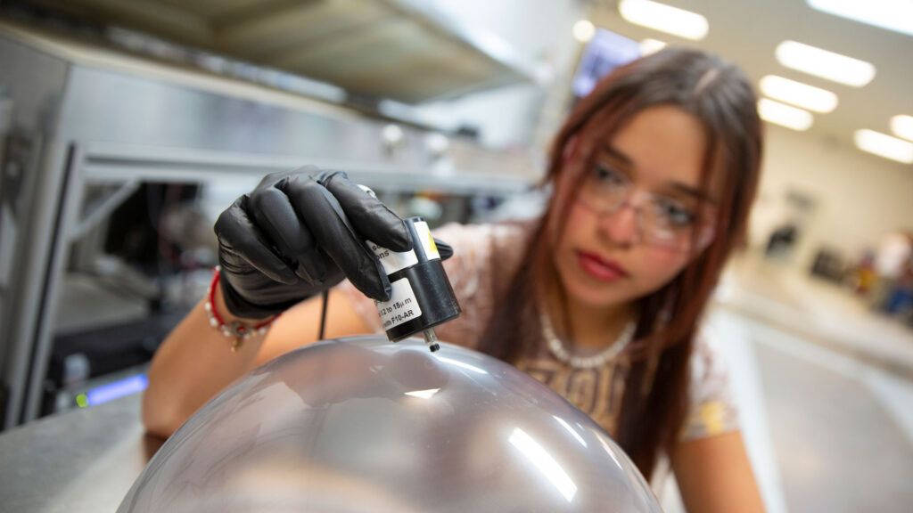 Abril Ramos works with lab equipment at Swift Coat.