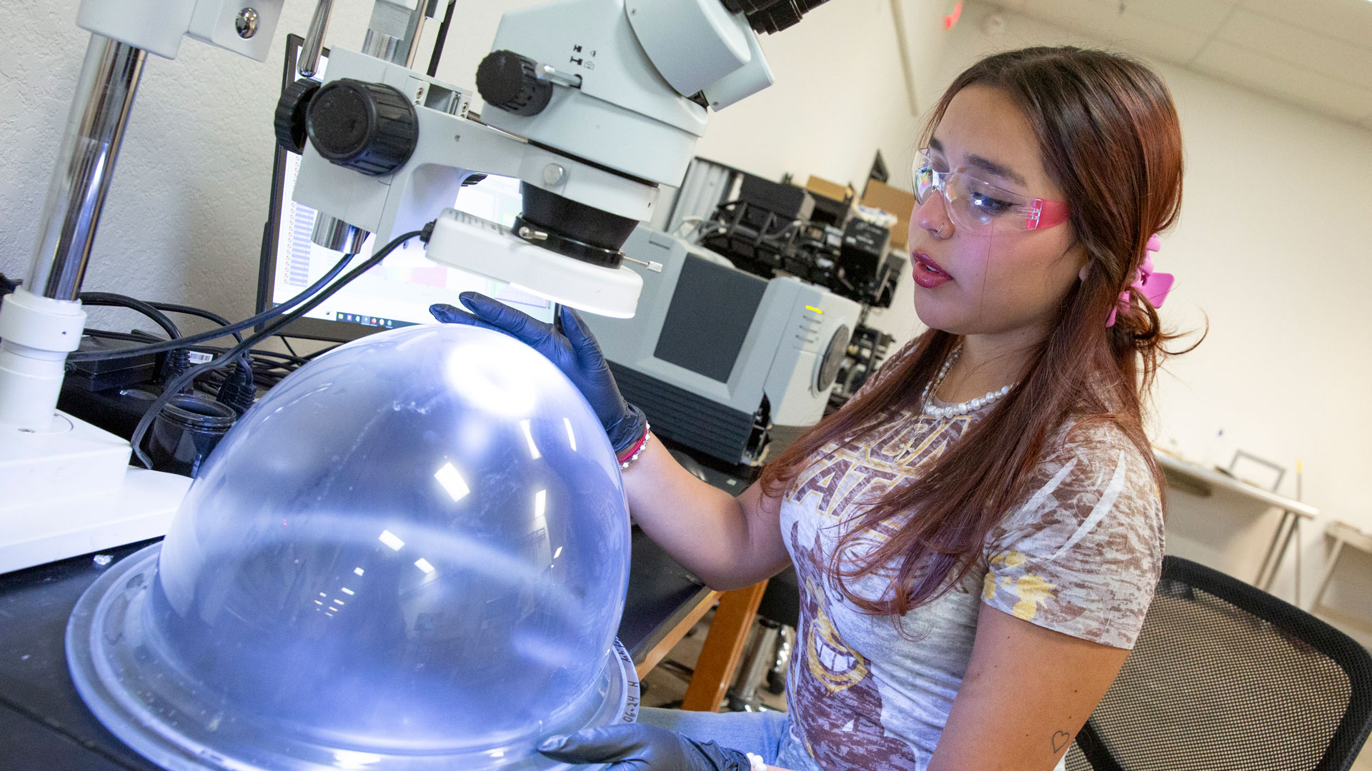 SEMTE-SwiftCoat-Abril-Ramos-2024-EG-5005-w-1920×1080 ASU student Abril Ramos works with a prototype of a NASA spacesuit helmet in the lab.