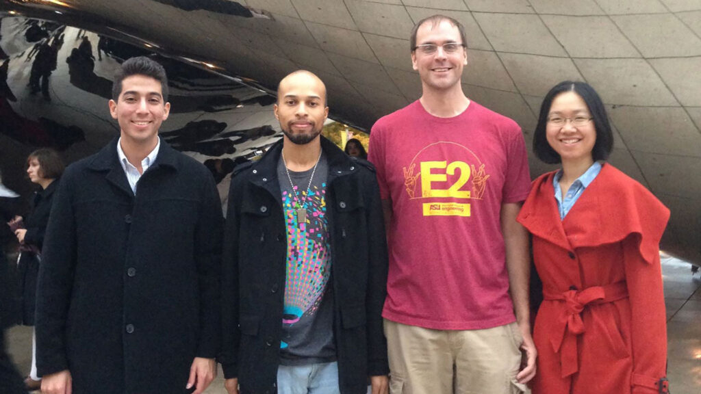 A team of student researchers from the Center for Accelerating and Operational Efficiency, or CAOE, poses with CAOE Director Ross Maciejewski in front of the Cloud Gate sculpture in Chicago 
