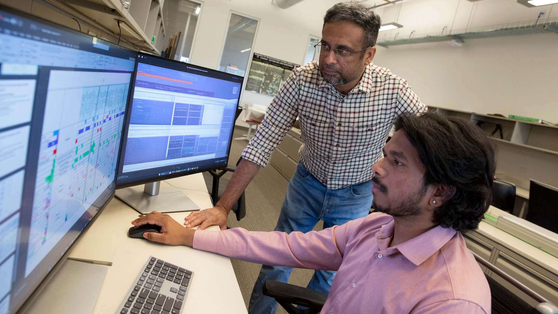 SSEBE-Dwarak-Ravikumar-Yum-2025-EG-7091-a-1920X1080-16X9-hero-web Fulton Schools Assistant Professor Dwarak Ravikumar, left, and Dileep Nakka, associate research technologist, right, review data in their joint research project with Yum! Brands on circular economy strategies to replace single-use cups with reusable cups. Photographer: Erika Gronek/ASU